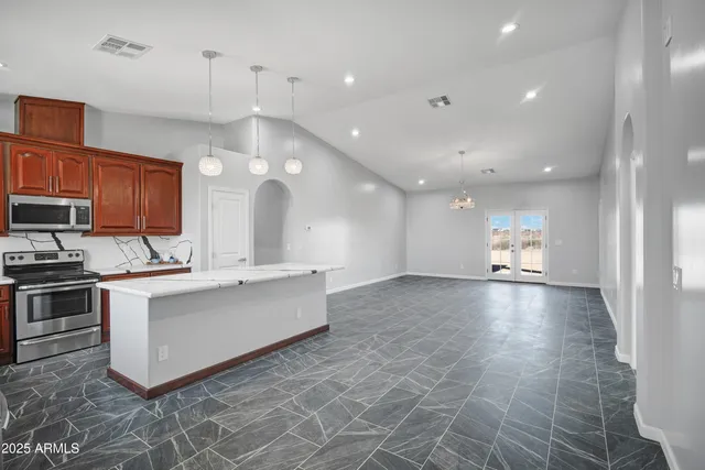 a view of kitchen with cabinets and window