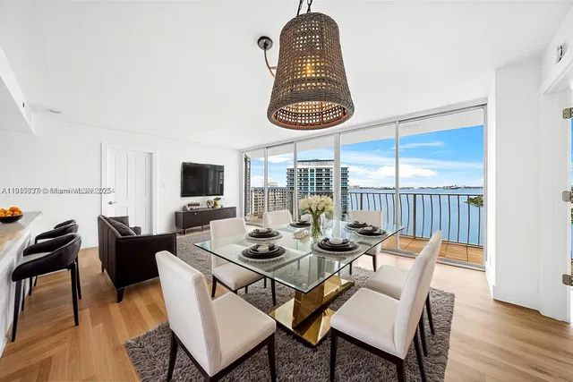 a dining room with furniture a rug and a chandelier