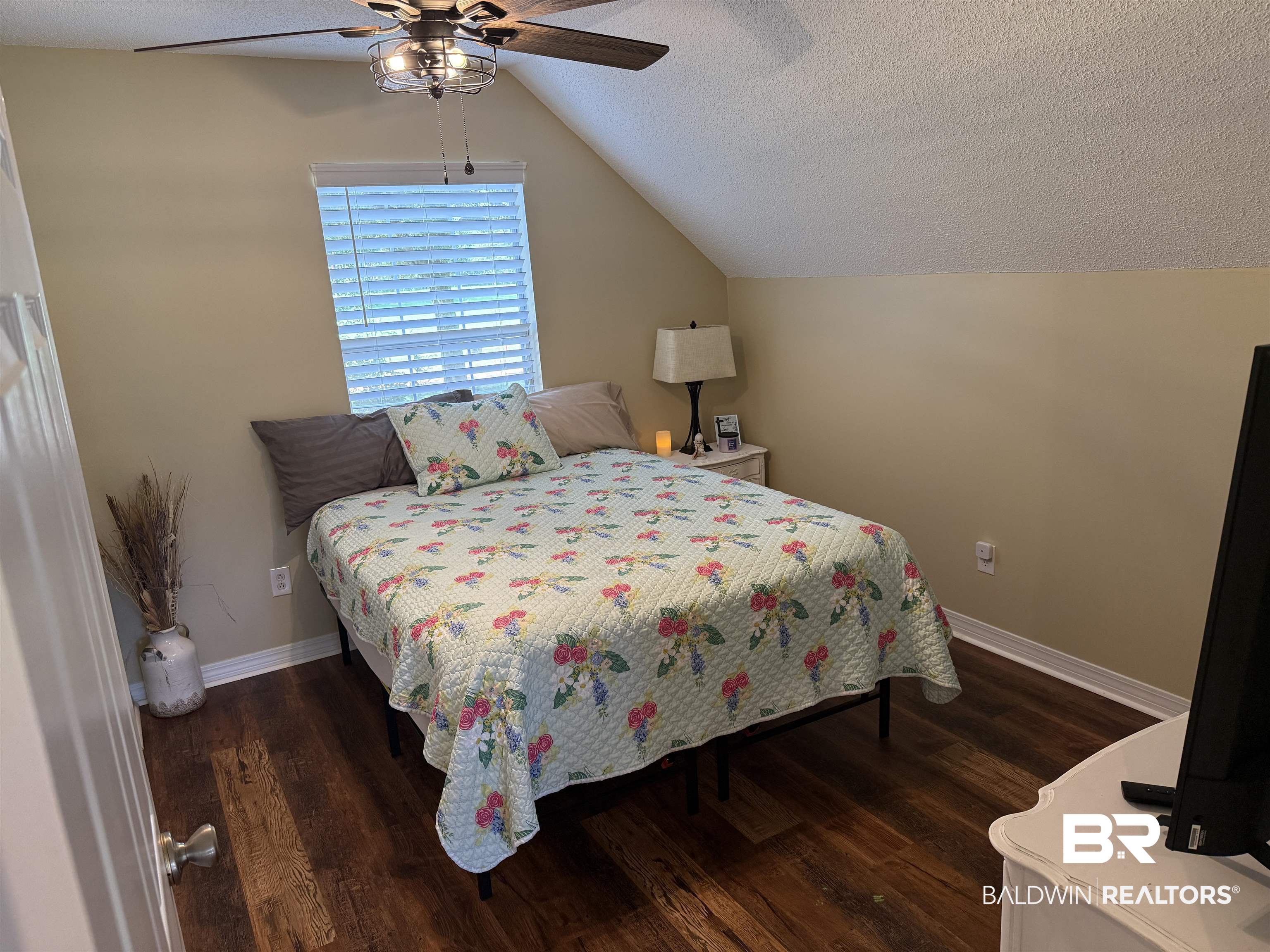 14601 Trawick Road Stapleton, AL 36578 - Photo 18 of 37 Bedroom featuring vaulted ceiling, wood finished floors, a textured ceiling, and ceiling fan