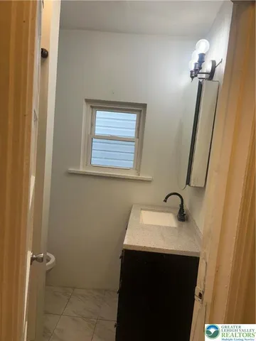 a bathroom with a sink and mirror