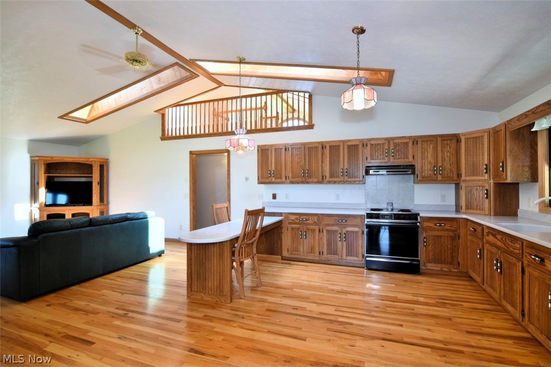 15227 Leroy Road Thompson, OH 44086 - Photo 29 of 50 View of the kitchen from the sunroom. Family room to the left. Skylights, vaulted ceiling and ceiling fan.