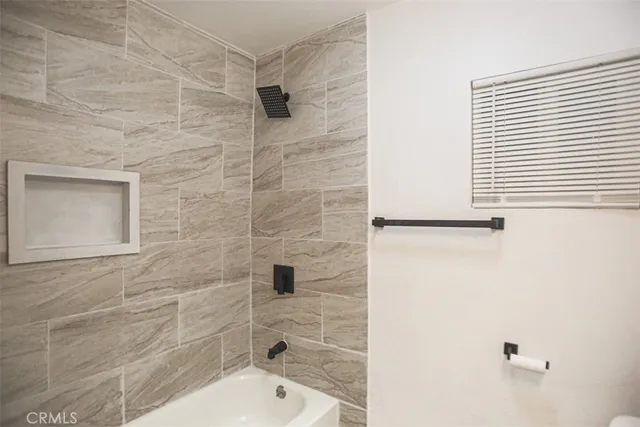 a bathroom with a bathtub and a shower