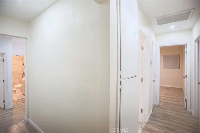 a view of a hallway with wooden floor