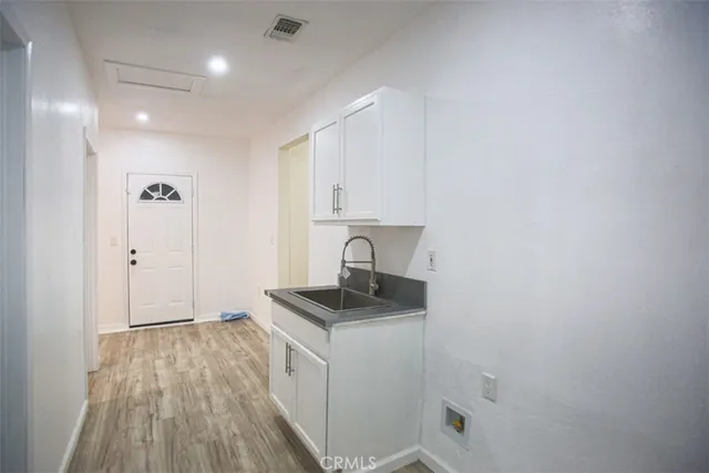 a view of a kitchen with a sink and cabinets
