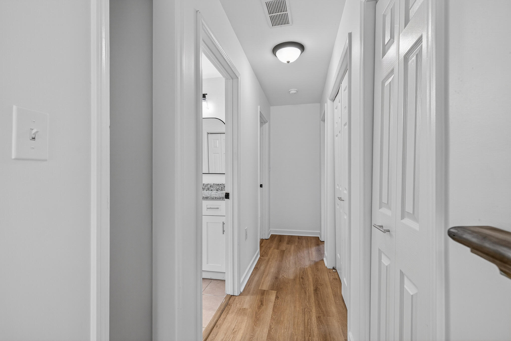 105 East Renoir Road DeFuniak Springs, FL 32433 - Photo 11 of 29 a view of a hallway with wooden floor and a bathroom
