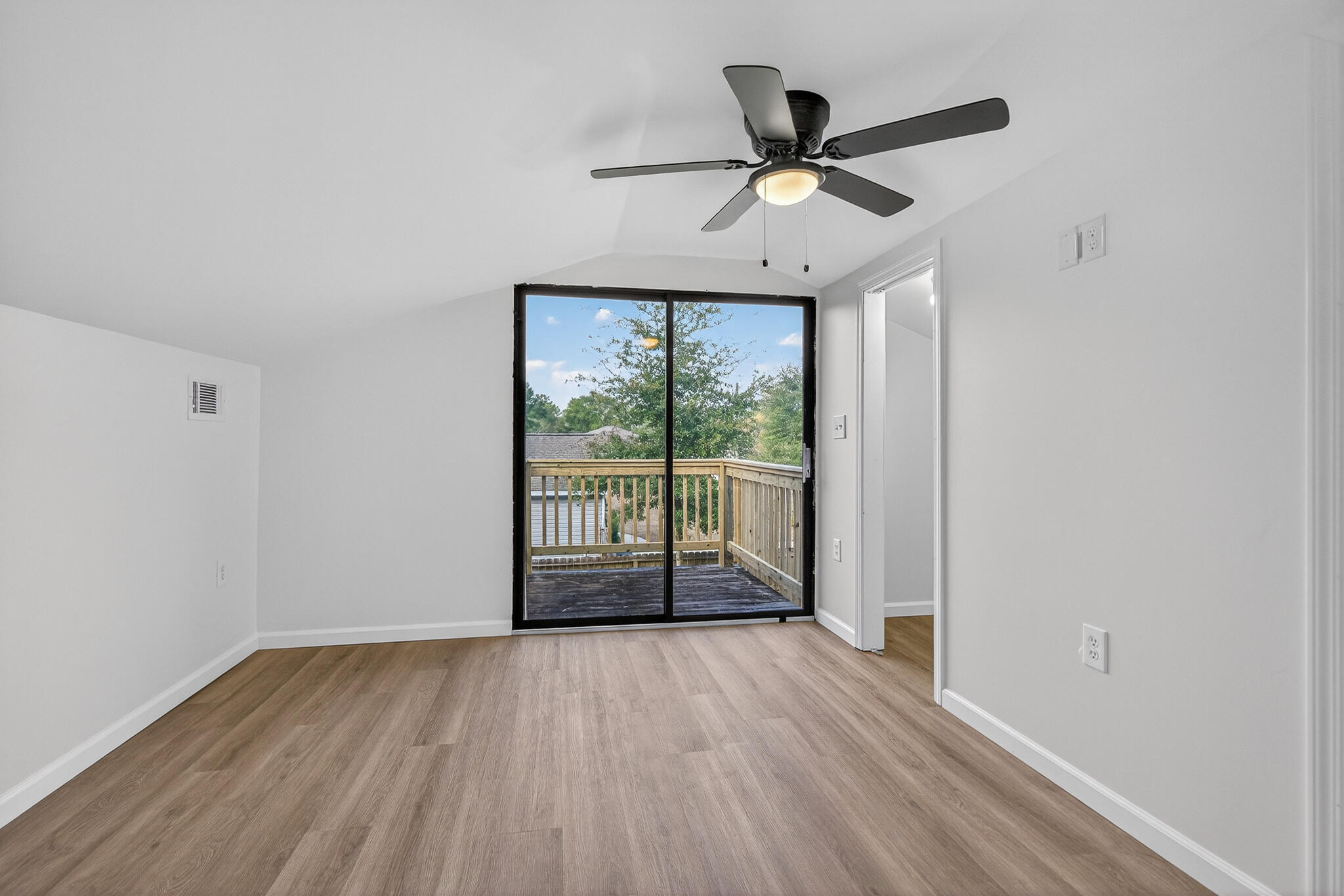 105 East Renoir Road DeFuniak Springs, FL 32433 - Photo 21 of 29 a view of a livingroom with wooden floor and a ceiling fan