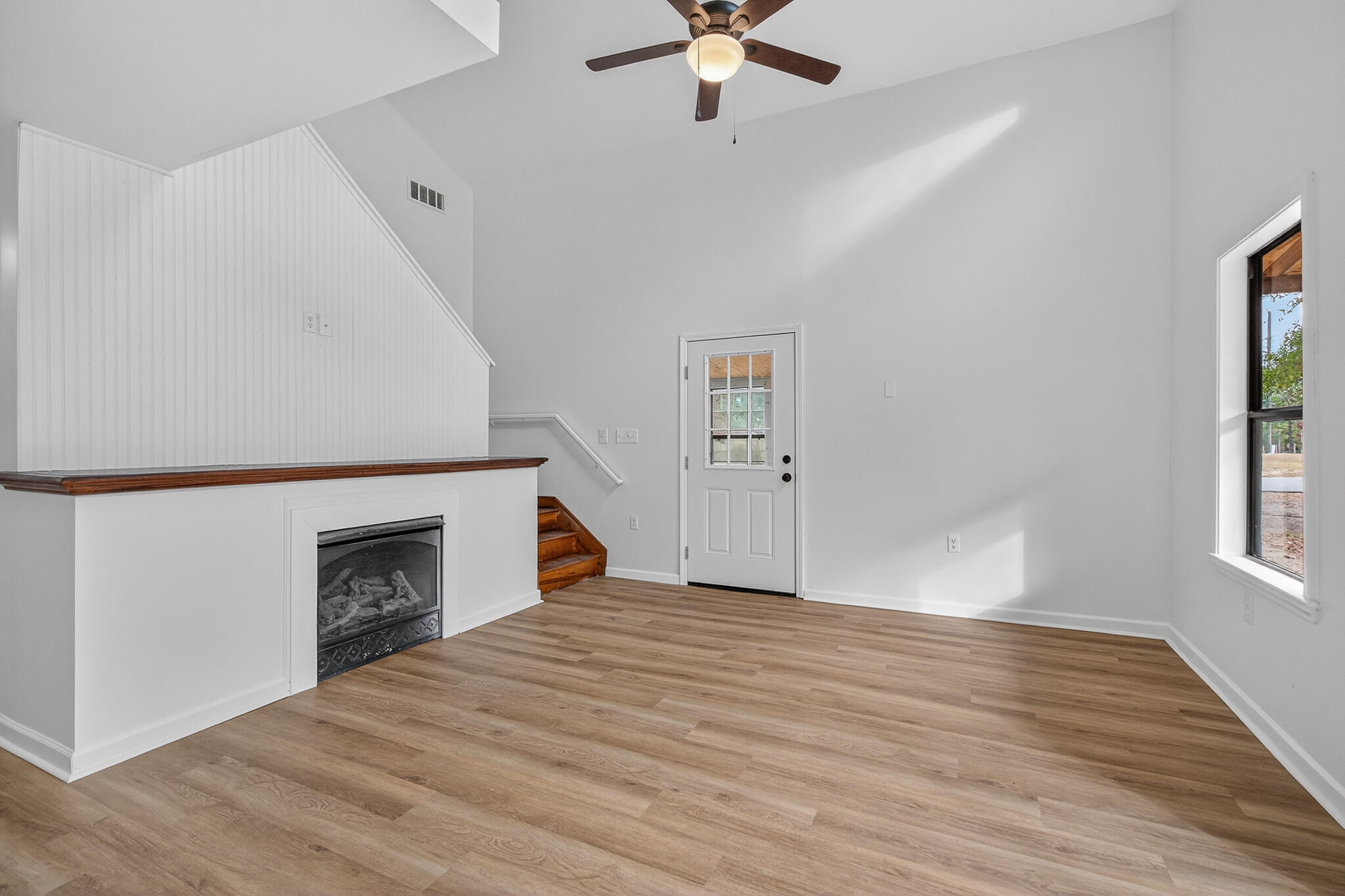 105 East Renoir Road DeFuniak Springs, FL 32433 - Photo 3 of 29 an empty room with windows and fireplace