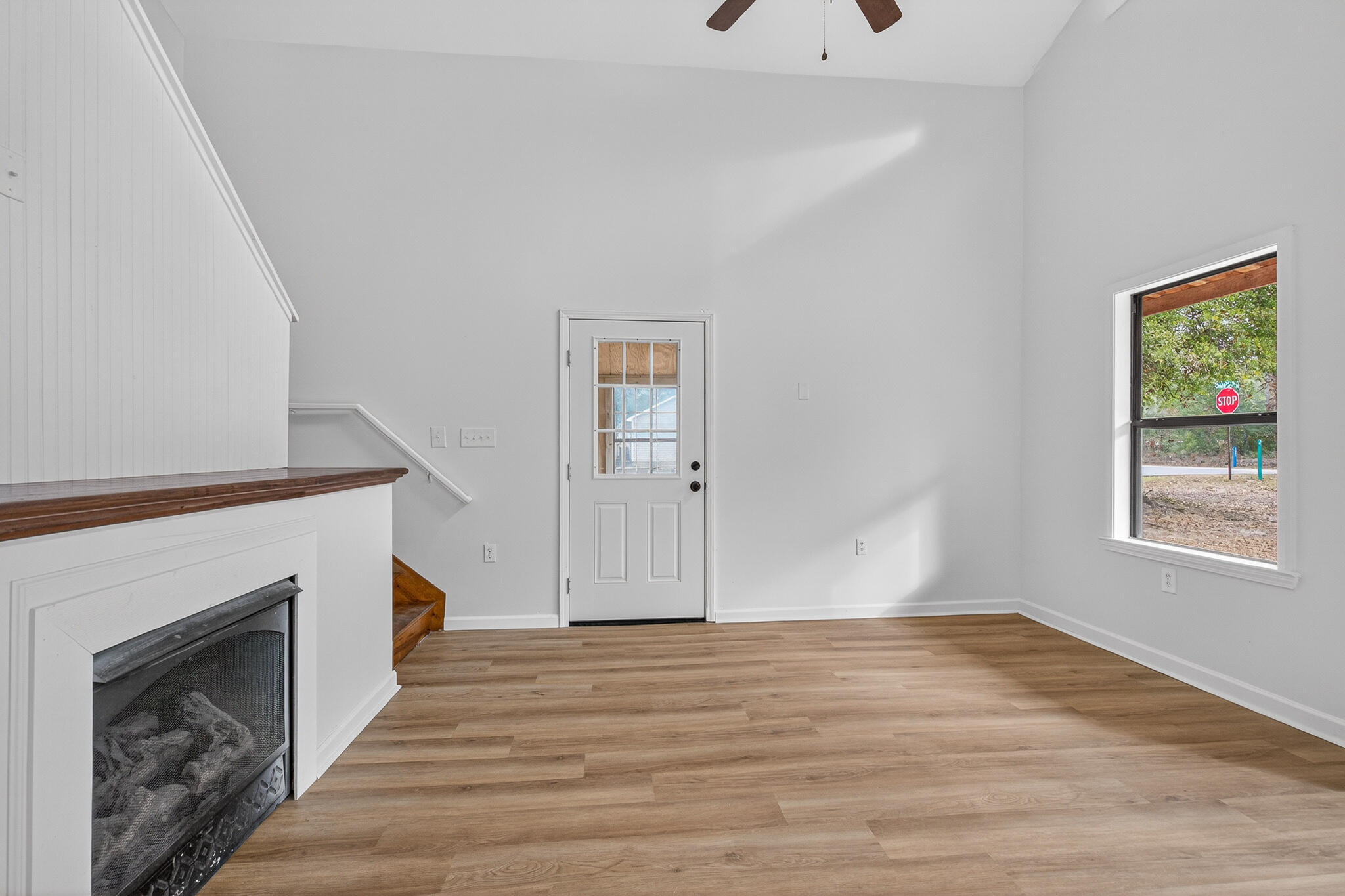 105 East Renoir Road DeFuniak Springs, FL 32433 - Photo 4 of 29 a view of an empty room with wooden floor and a window