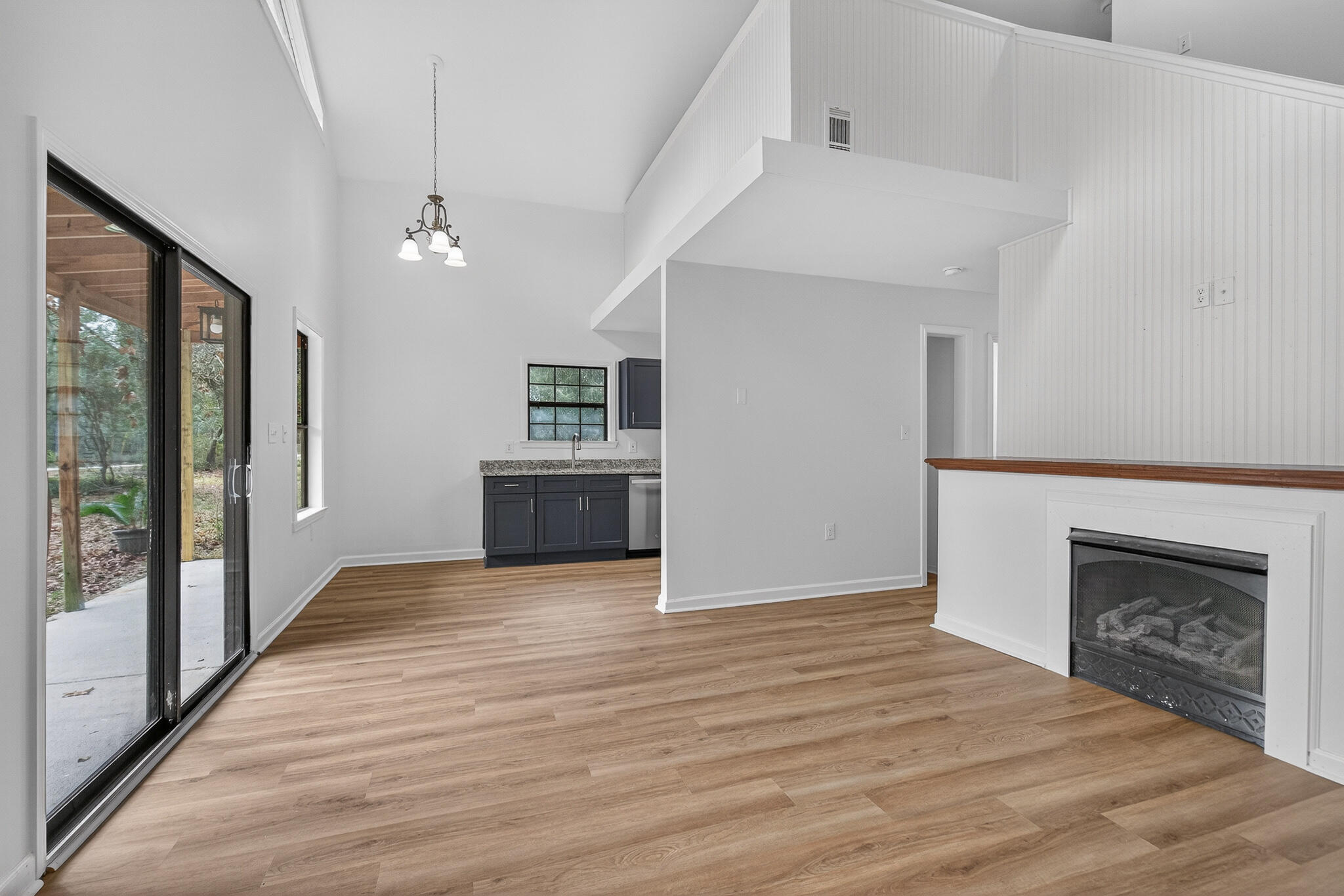 105 East Renoir Road DeFuniak Springs, FL 32433 - Photo 6 of 29 a view of a livingroom with wooden floor and a fireplace