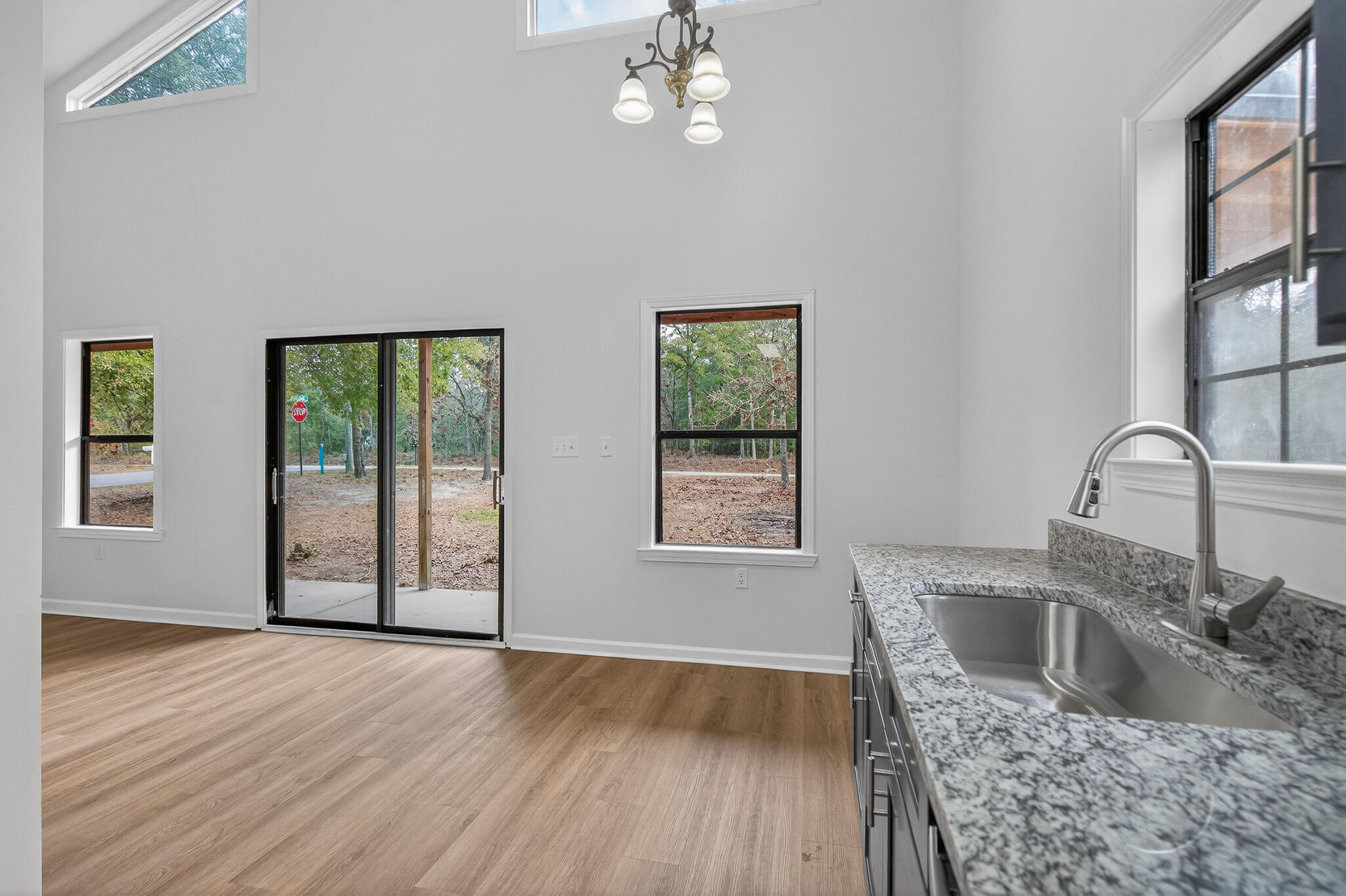 105 East Renoir Road DeFuniak Springs, FL 32433 - Photo 10 of 29 a kitchen with stainless steel appliances granite countertop a sink dishwasher a stove with wooden floor