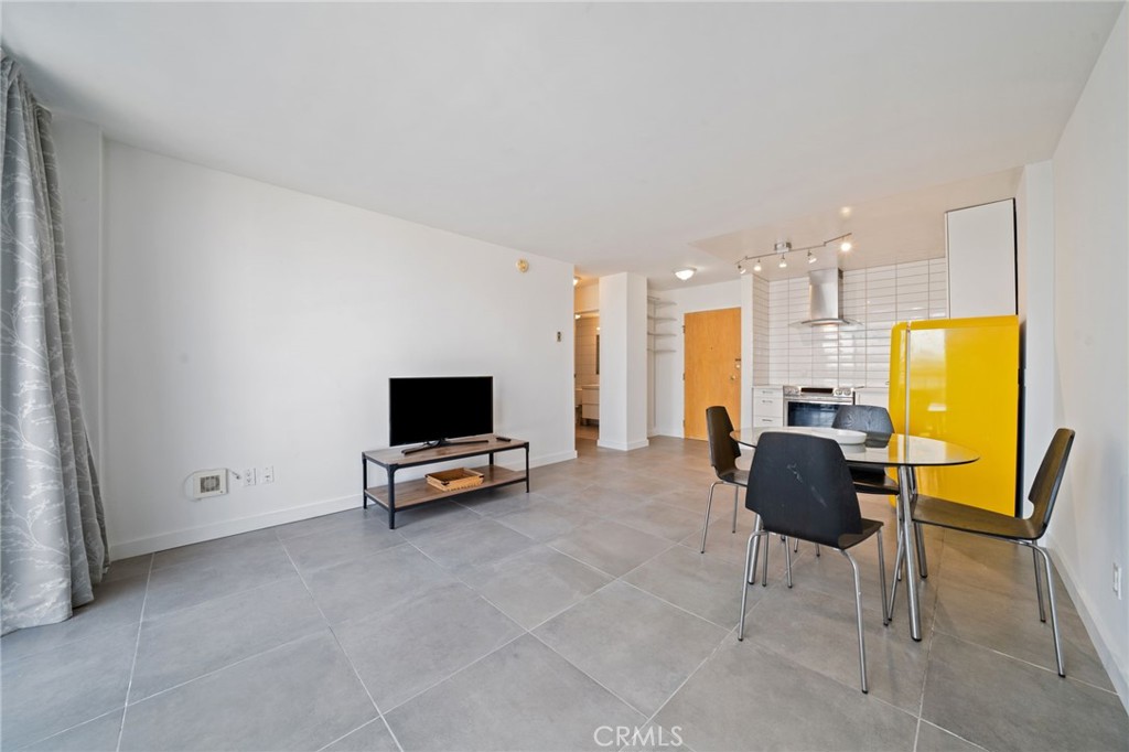 375 Atlantic Avenue, Unit 201 Long Beach, CA 90802 - Photo 12 of 21 a living room with furniture and a flat screen tv