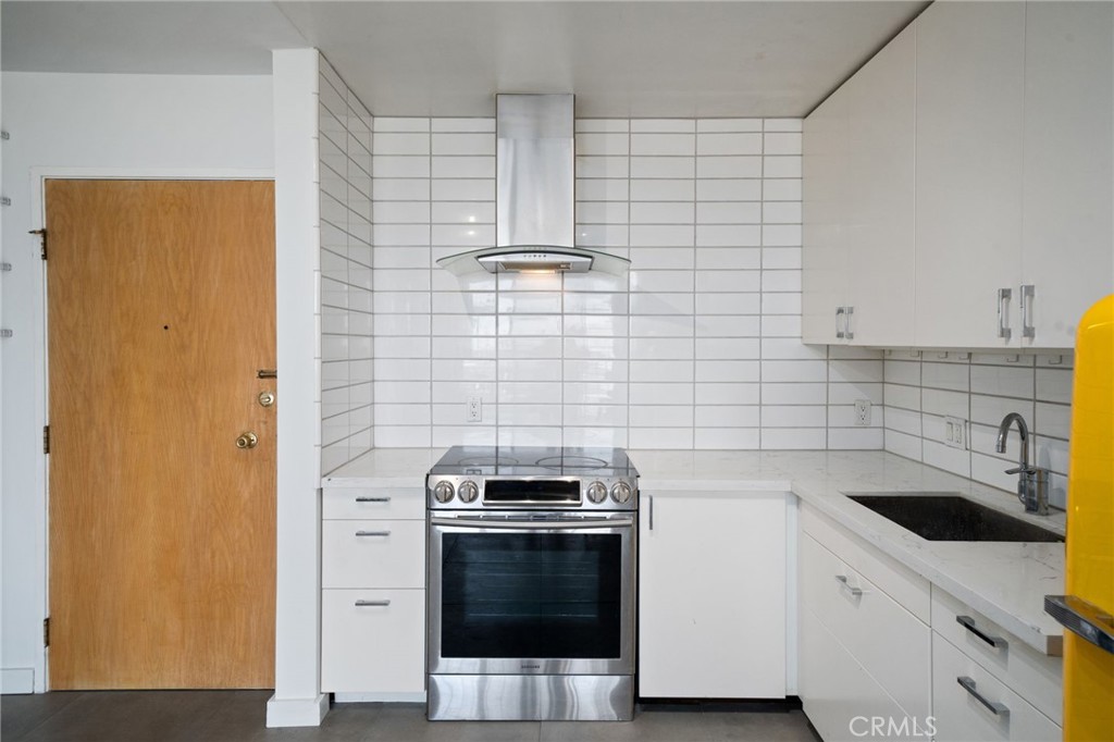 375 Atlantic Avenue, Unit 201 Long Beach, CA 90802 - Photo 14 of 21 a kitchen with a sink and a stove top oven