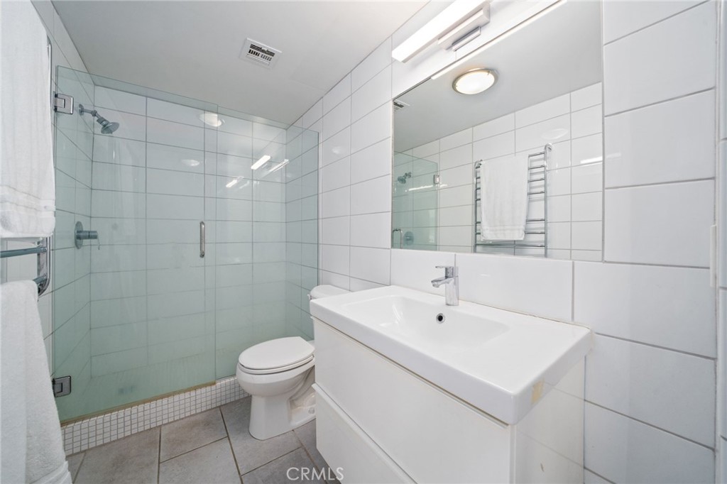 375 Atlantic Avenue, Unit 201 Long Beach, CA 90802 - Photo 19 of 21 a bathroom with a sink a toilet and shower