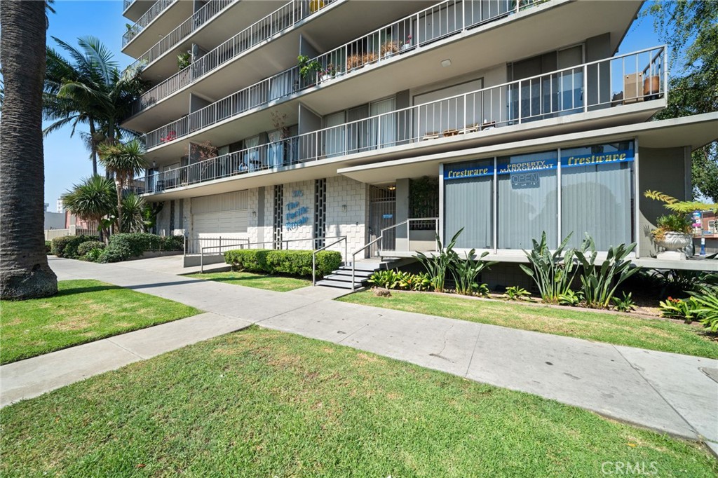375 Atlantic Avenue, Unit 201 Long Beach, CA 90802 - Photo 4 of 21 a front view of a building with a garden and plants