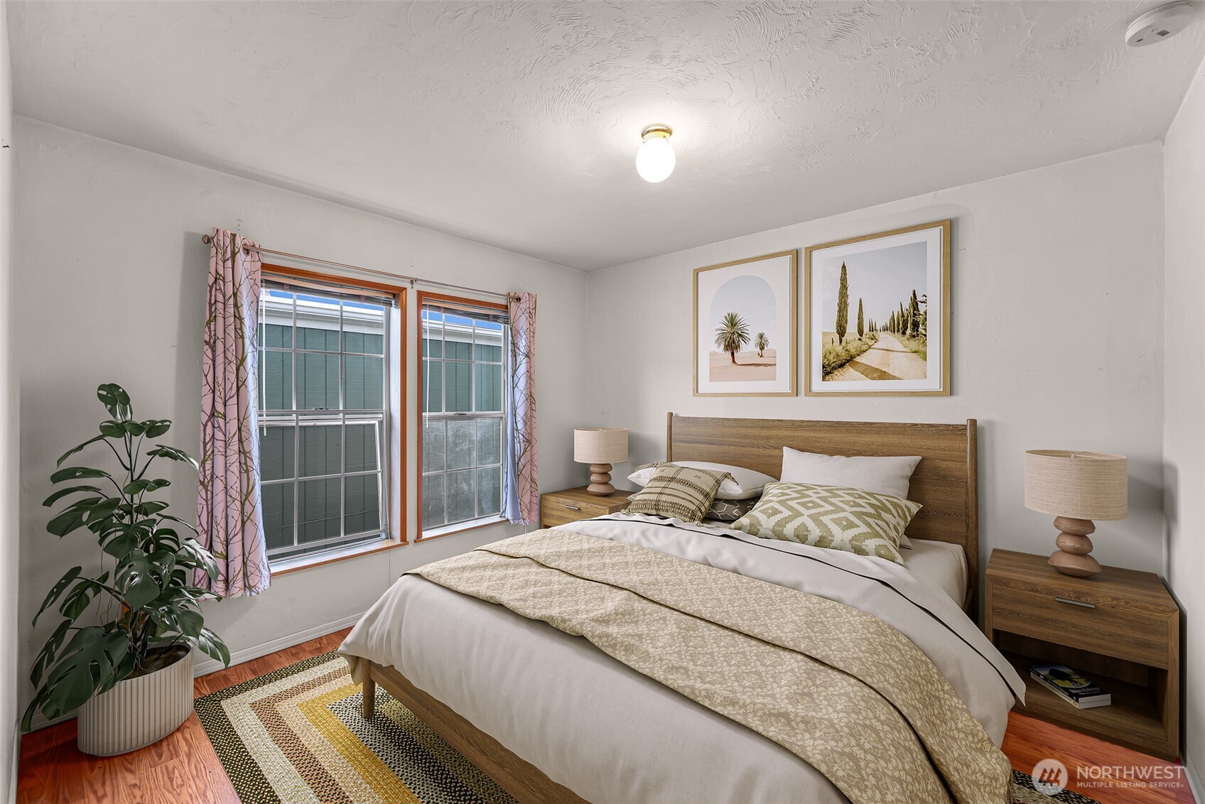 2015 24th Street, Unit 101 Bellingham, WA 98225 - Photo 11 of 40 a bedroom with bed and large window with potted plants