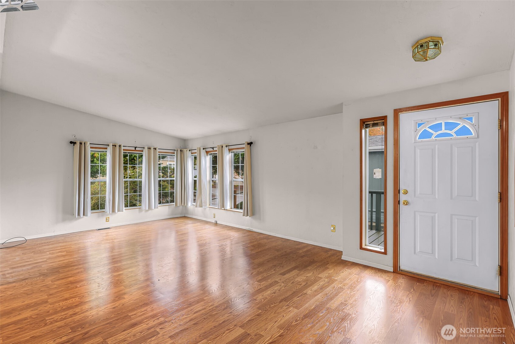 2015 24th Street, Unit 101 Bellingham, WA 98225 - Photo 14 of 40 a view of an empty room with wooden floor and a window