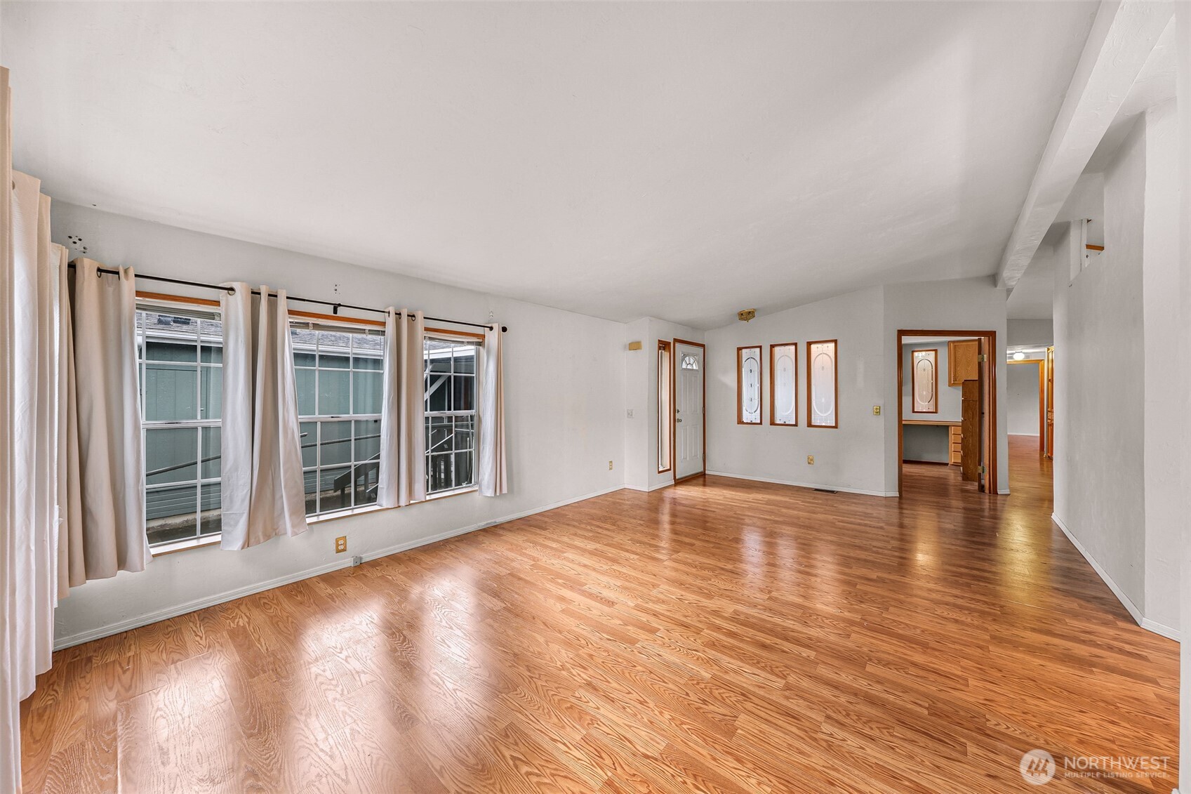 2015 24th Street, Unit 101 Bellingham, WA 98225 - Photo 15 of 40 a view of an empty room with wooden floor and a window