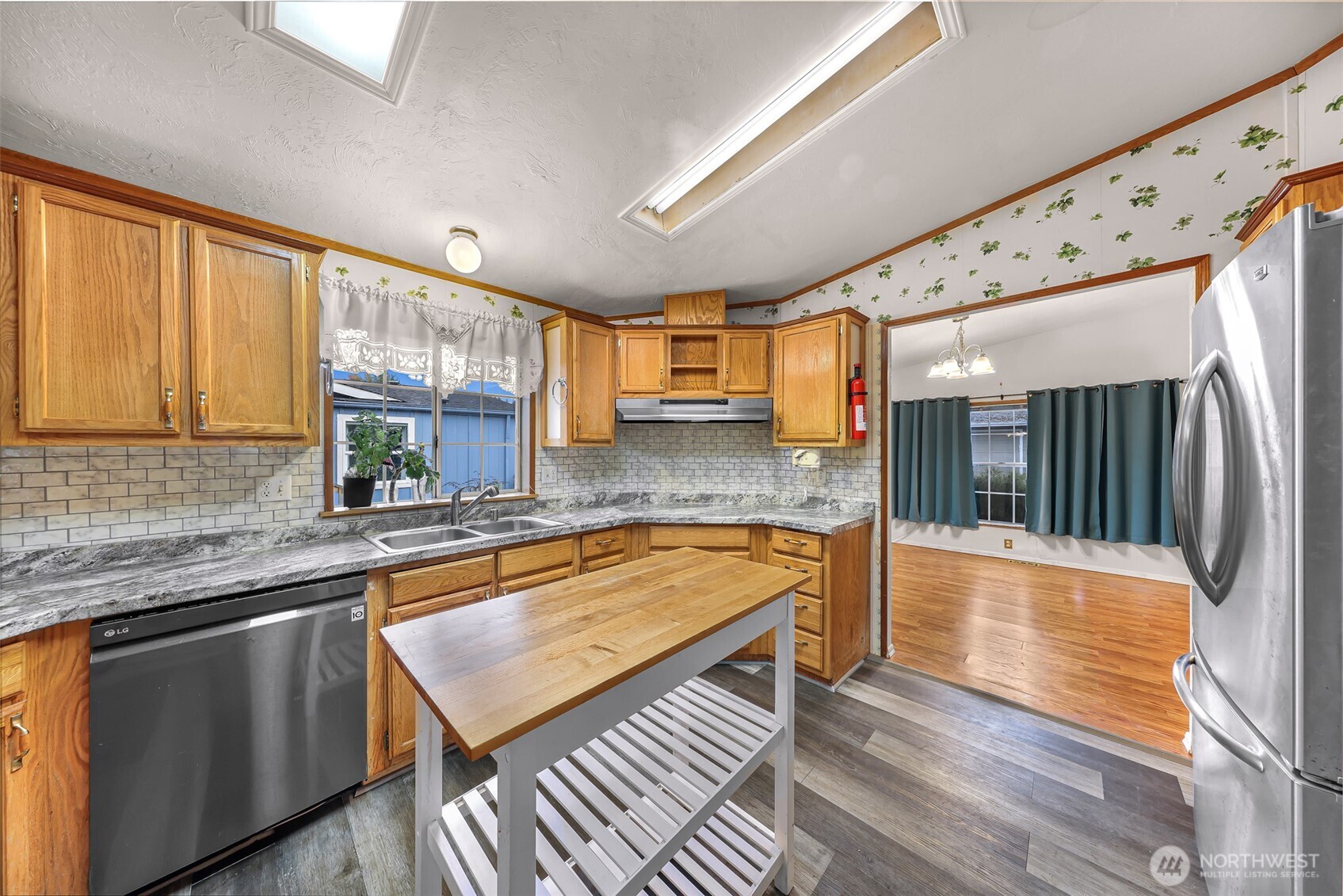 2015 24th Street, Unit 101 Bellingham, WA 98225 - Photo 21 of 40 a kitchen with stainless steel appliances granite countertop a sink a stove counter space and cabinets