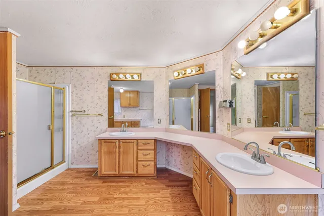 a large bathroom with a granite countertop sink a bathtub and mirror