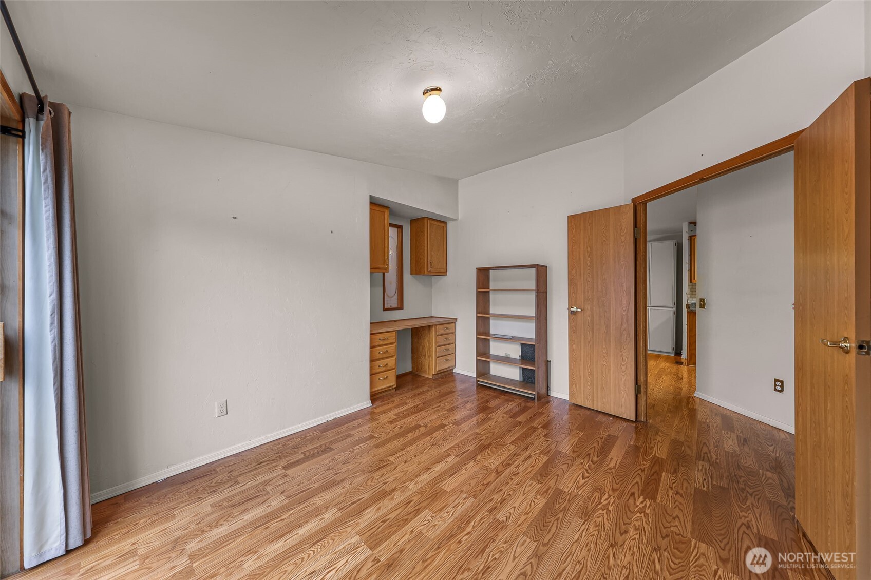 2015 24th Street, Unit 101 Bellingham, WA 98225 - Photo 31 of 40 a view of a livingroom with wooden floor and kitchen space
