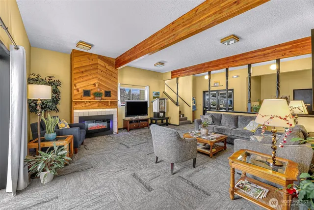 a living room with lots of wooden furniture and a table