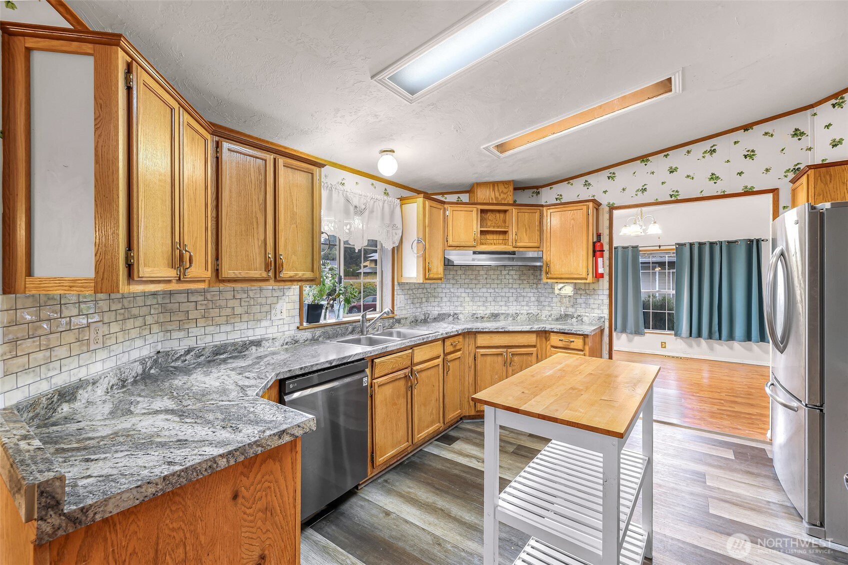 2015 24th Street, Unit 101 Bellingham, WA 98225 - Photo 7 of 40 a kitchen with stainless steel appliances granite countertop sink stove and refrigerator