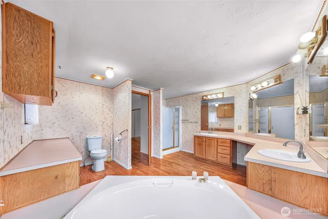 a bedroom with bed and large window with potted plants