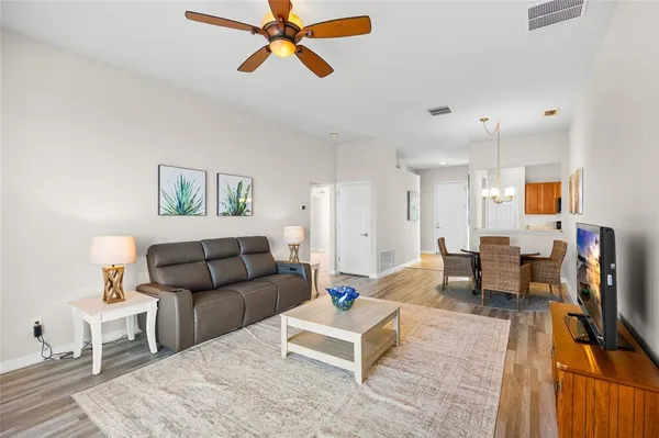 a living room with furniture and a wooden floor