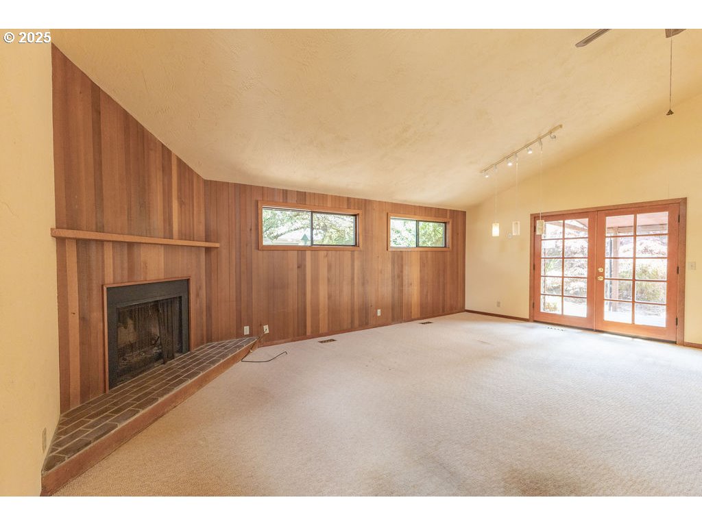 2116 Sally Way Eugene, OR 97401 - Photo 15 of 39 a view of an empty room with a fireplace and a window
