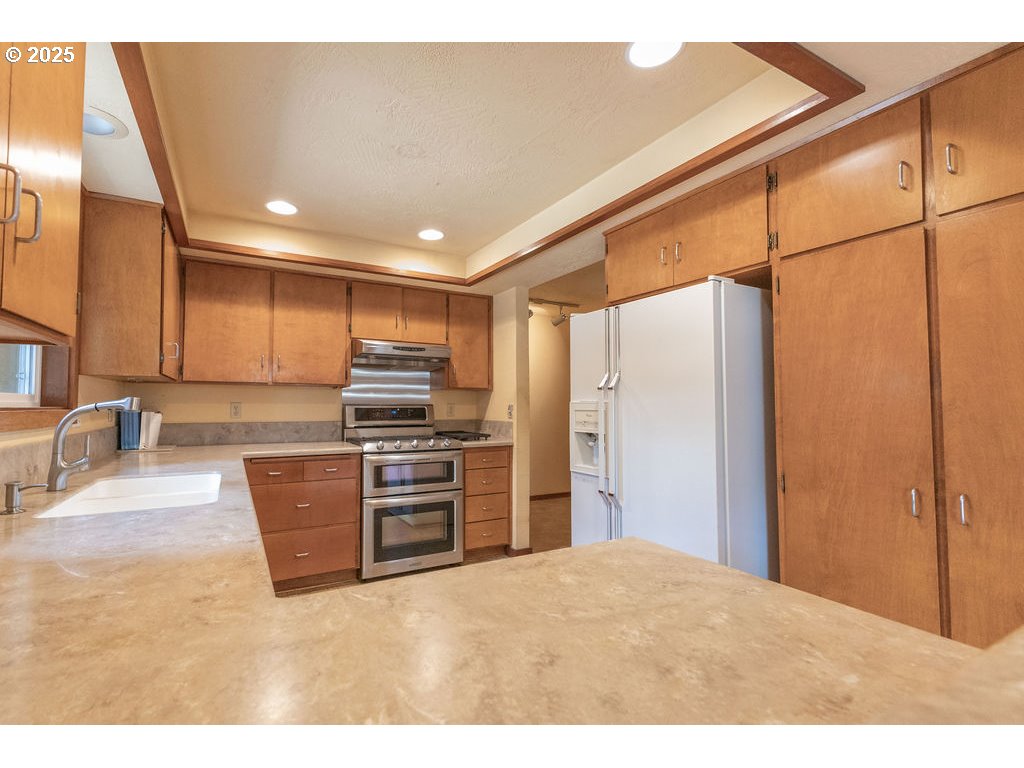 2116 Sally Way Eugene, OR 97401 - Photo 17 of 39 a kitchen with granite countertop a refrigerator and a sink