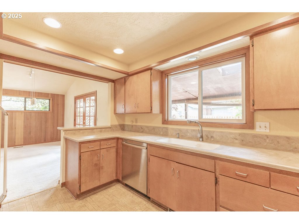 2116 Sally Way Eugene, OR 97401 - Photo 19 of 39 a kitchen with a sink cabinets appliances and a large window