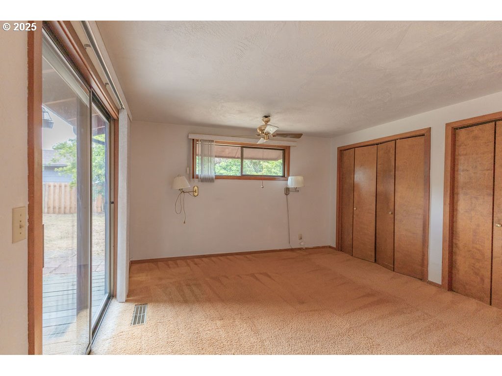 2116 Sally Way Eugene, OR 97401 - Photo 27 of 39 a view of an empty room with wooden floor and windows