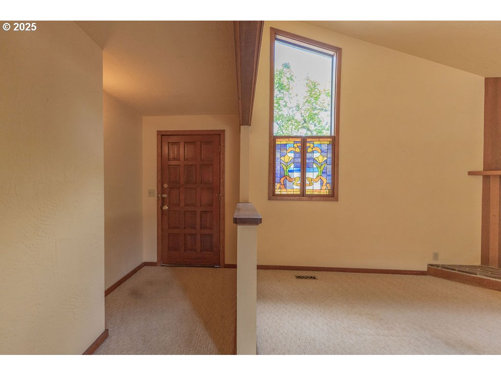 2116 Sally Way Eugene, OR 97401 - Photo 8 of 39 a view of an empty room with wooden floor and a window