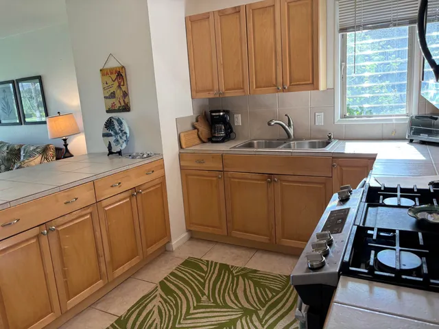 a kitchen with sink window and cabinets