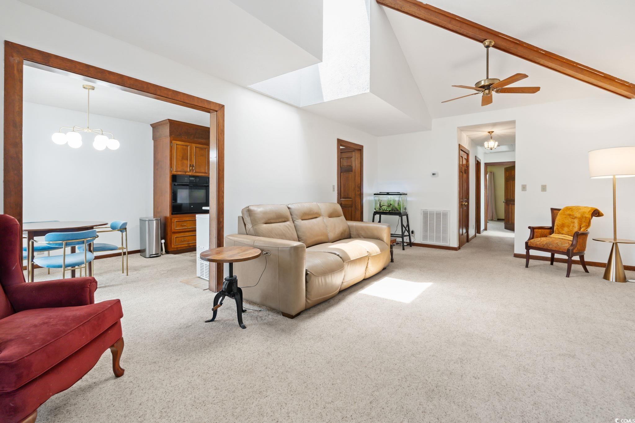 3533 Lighthouse Way Myrtle Beach, SC 29577 - Photo 11 of 40 Living room with light colored carpet, vaulted ceiling, ceiling fan, and a chandelier