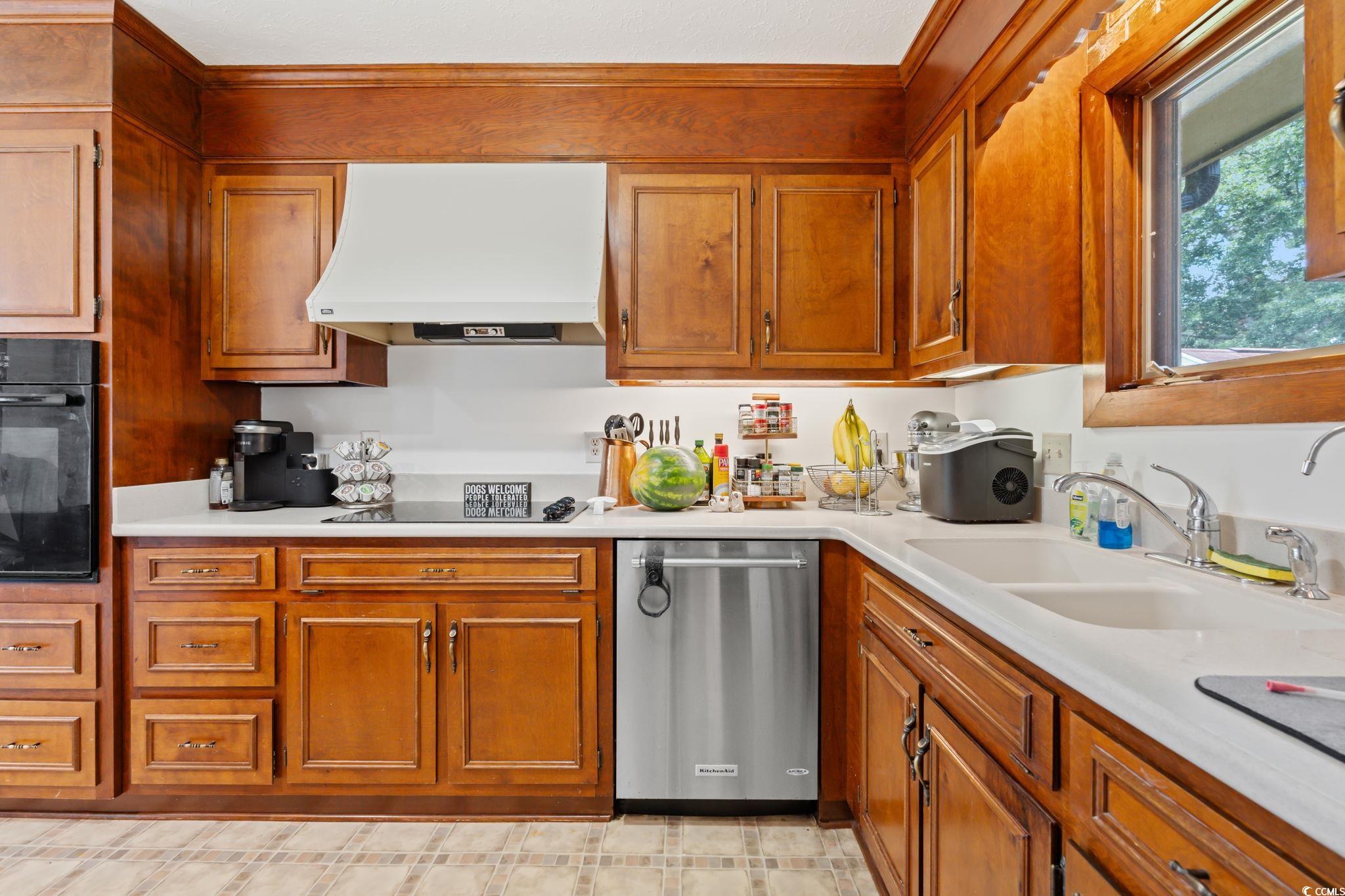 3533 Lighthouse Way Myrtle Beach, SC 29577 - Photo 15 of 40 Kitchen featuring range hood, black appliances, and brown cabinetry