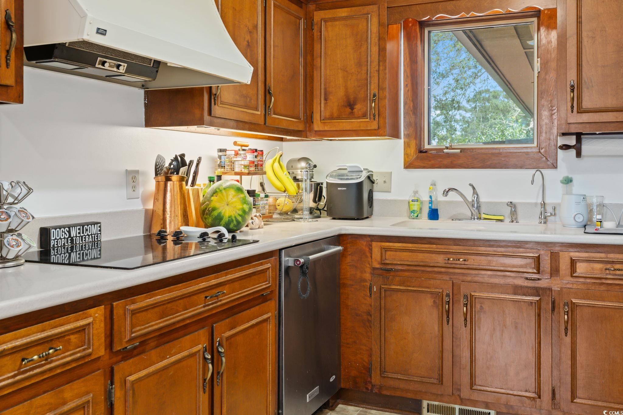 3533 Lighthouse Way Myrtle Beach, SC 29577 - Photo 16 of 40 Kitchen with exhaust hood, black electric cooktop, and light countertops