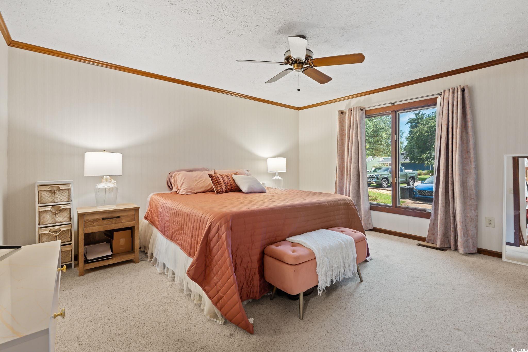 3533 Lighthouse Way Myrtle Beach, SC 29577 - Photo 20 of 40 Bedroom featuring crown molding, light colored carpet, a ceiling fan, and a textured ceiling