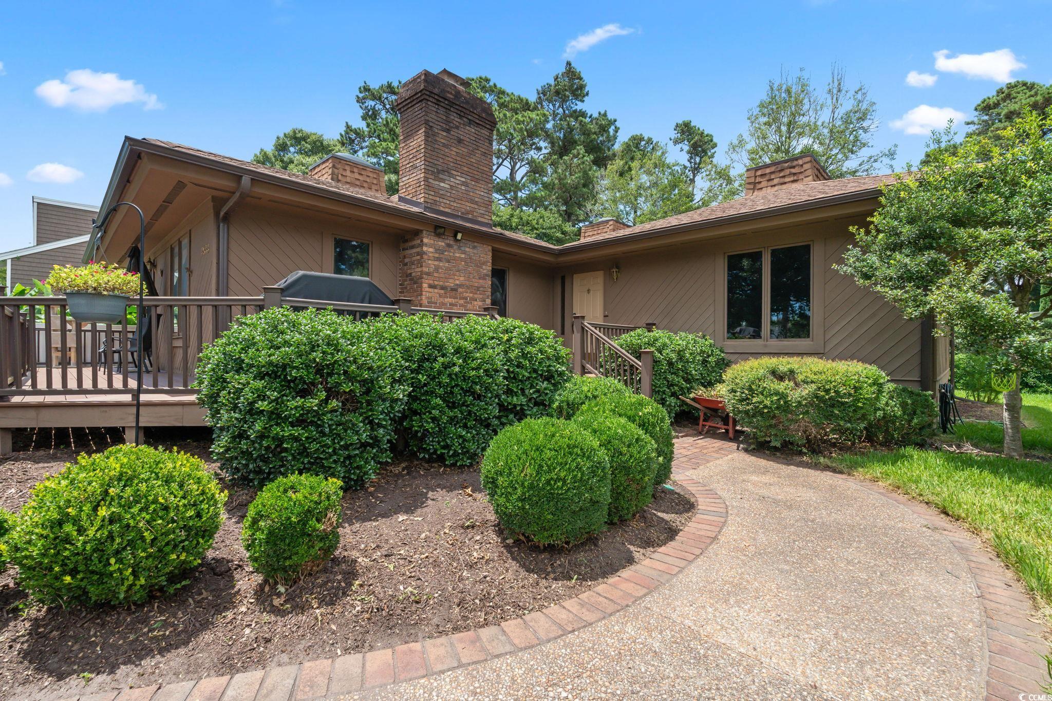 3533 Lighthouse Way Myrtle Beach, SC 29577 - Photo 2 of 40 View of front of house with a chimney and a wooden deck