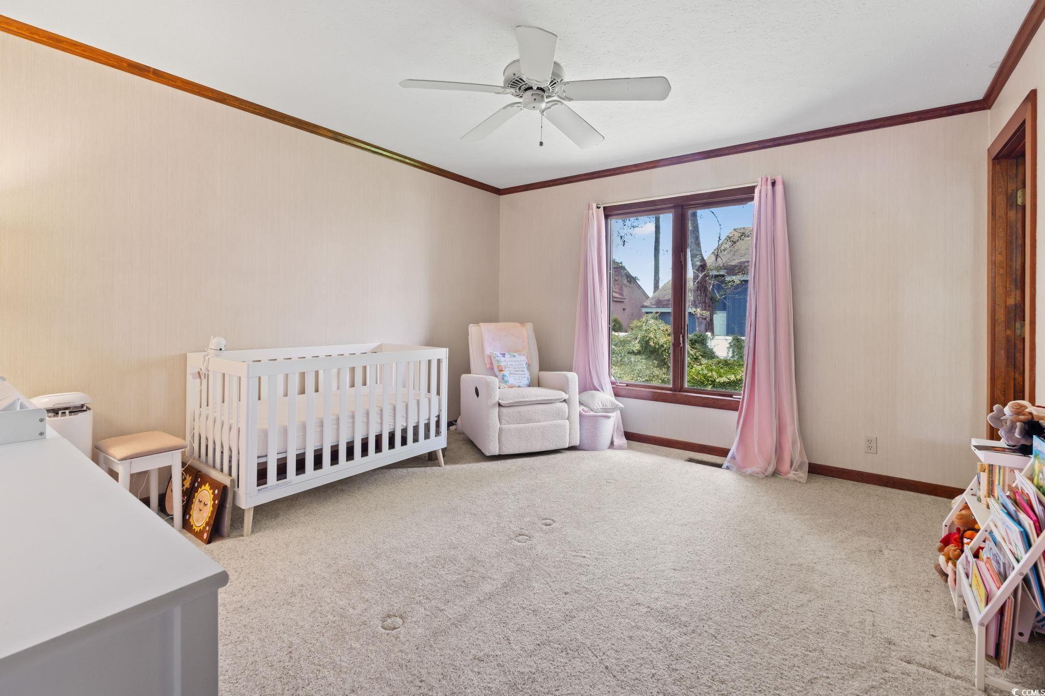 3533 Lighthouse Way Myrtle Beach, SC 29577 - Photo 24 of 40 Carpeted bedroom with crown molding, a nursery area, and a ceiling fan