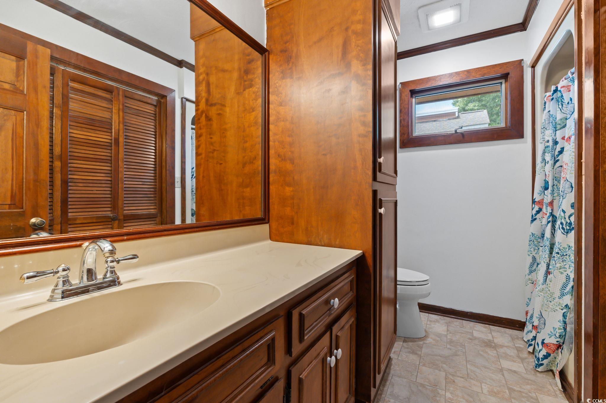 3533 Lighthouse Way Myrtle Beach, SC 29577 - Photo 30 of 40 Full bathroom featuring vanity, stone finish flooring, and a shower with shower curtain