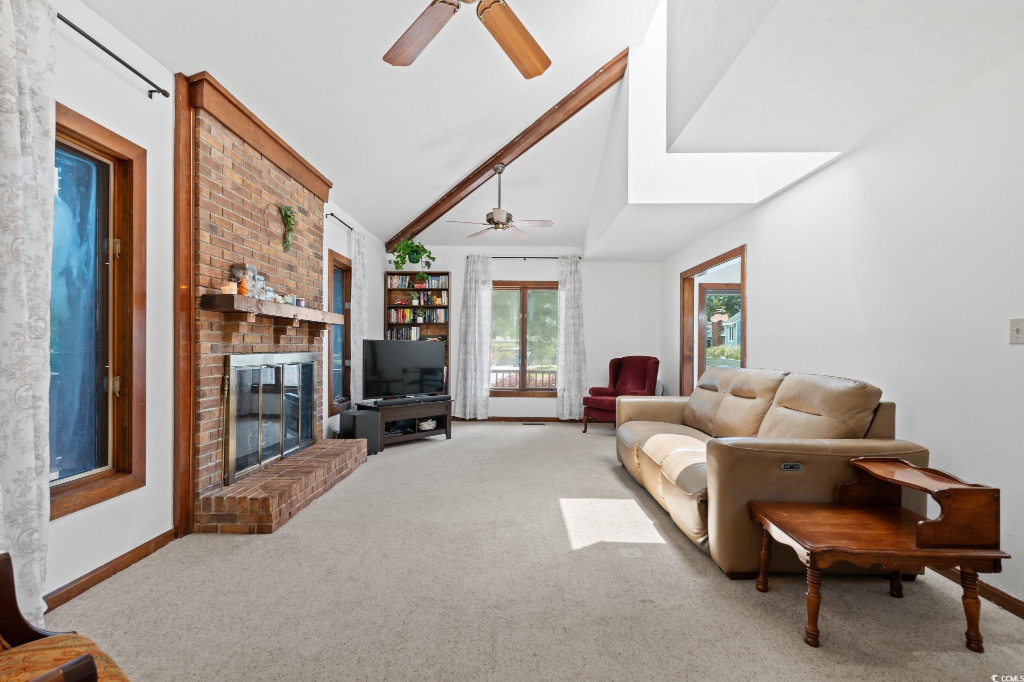 3533 Lighthouse Way Myrtle Beach, SC 29577 - Photo 6 of 40 Carpeted living room with a ceiling fan, a brick fireplace, and vaulted ceiling