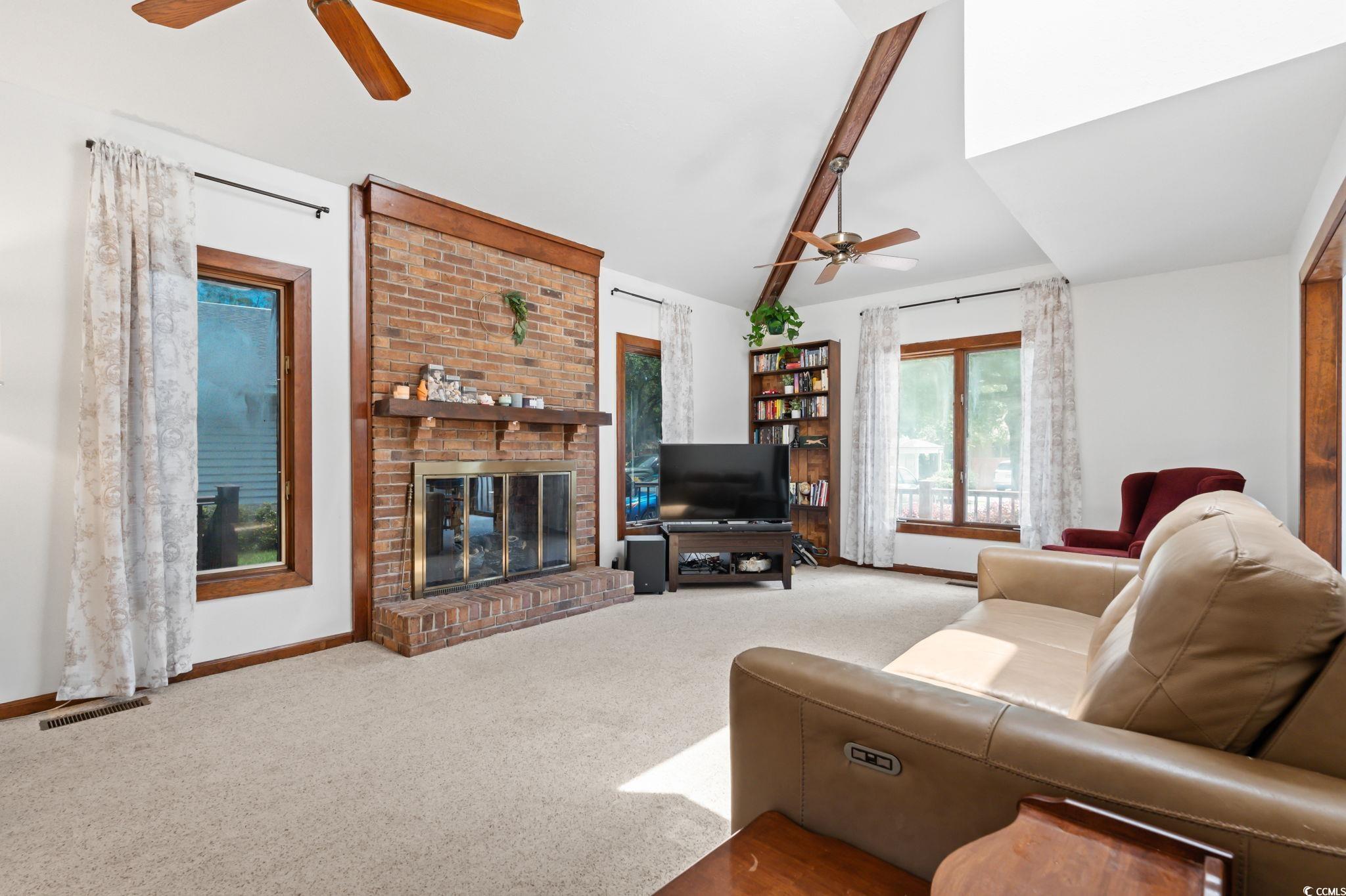 3533 Lighthouse Way Myrtle Beach, SC 29577 - Photo 7 of 40 Living area with a ceiling fan, carpet flooring, a fireplace, and lofted ceiling
