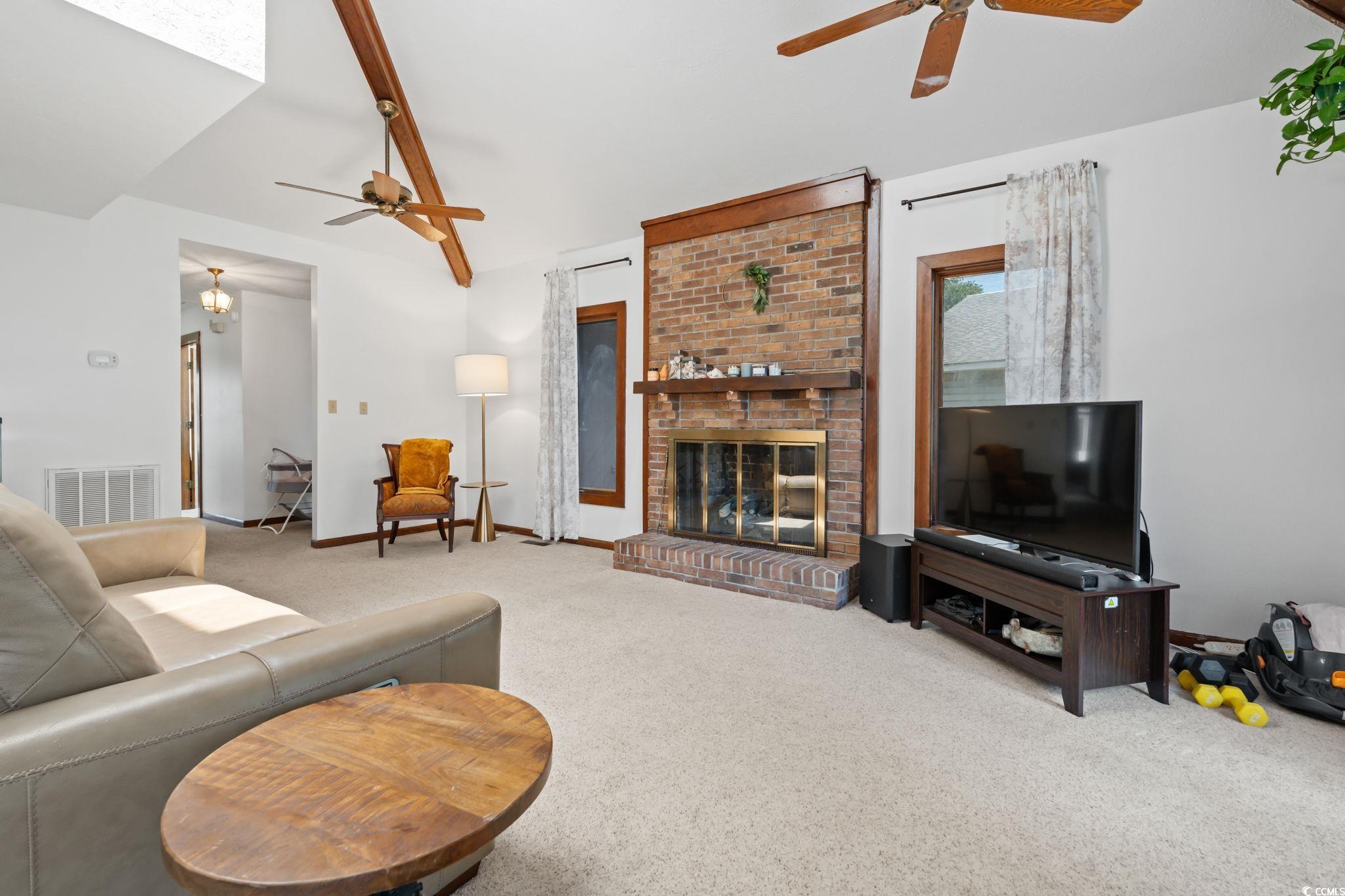 3533 Lighthouse Way Myrtle Beach, SC 29577 - Photo 9 of 40 Carpeted living room featuring a ceiling fan and a brick fireplace