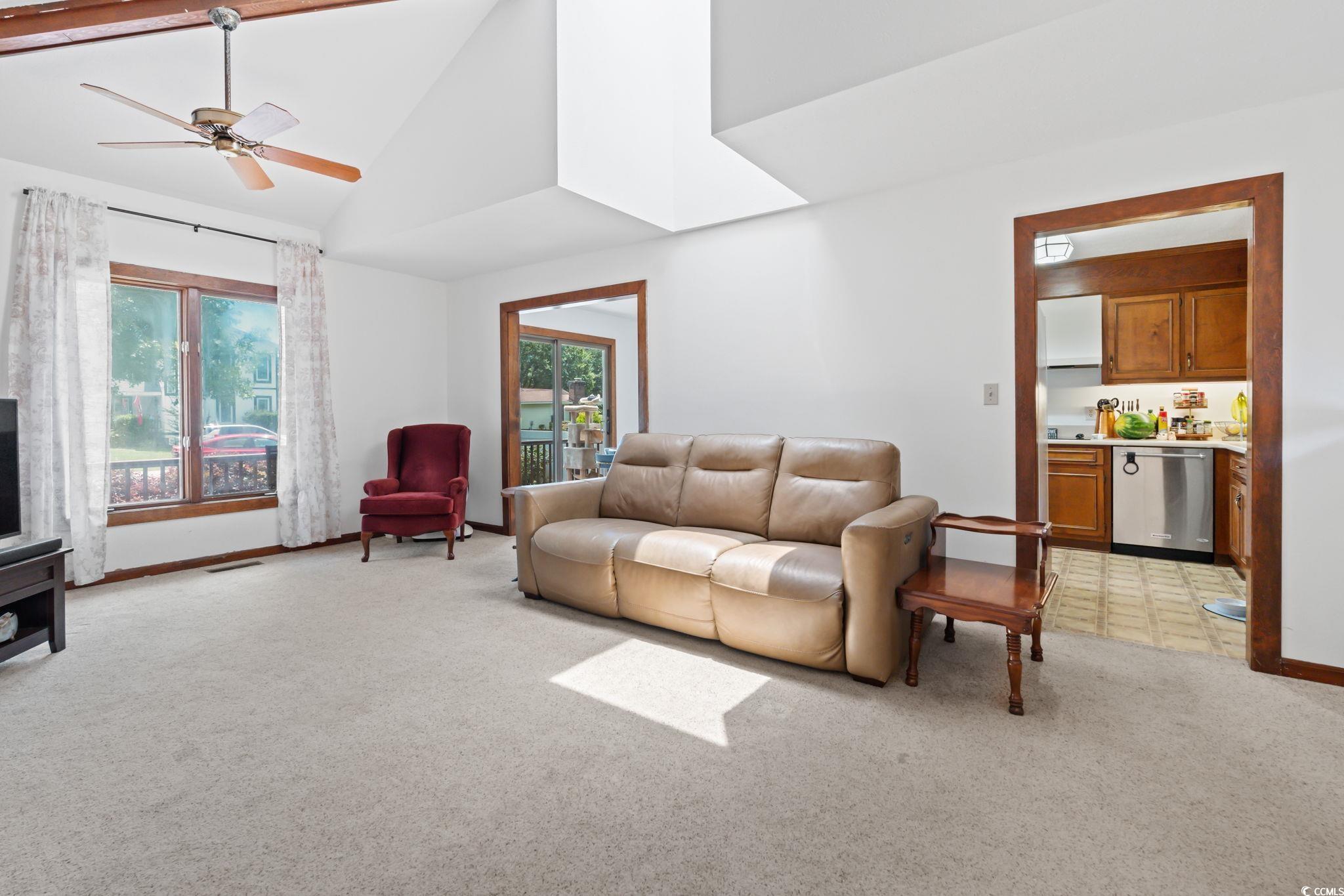 3533 Lighthouse Way Myrtle Beach, SC 29577 - Photo 10 of 40 Living room with light colored carpet, plenty of natural light, high vaulted ceiling, and ceiling fan