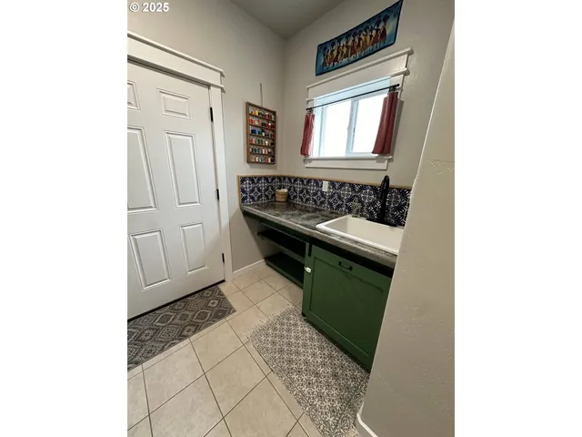 a bathroom with a toilet sink vanity and mirror