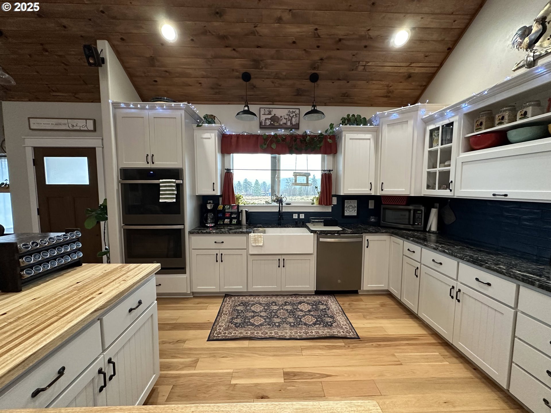 34786 Pleasant View Road Chiloquin, OR 97624 - Photo 7 of 48 a large kitchen with stainless steel appliances kitchen island granite countertop a sink and white cabinets
