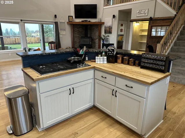 a kitchen with stainless steel appliances granite countertop a sink and cabinets