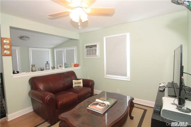 20 Point Road Riverhead, NY 11901 - Photo 1 of 1 a living room with furniture a flat screen tv and a window
