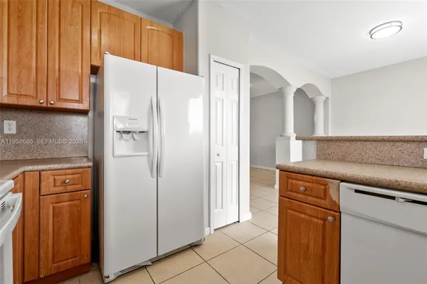 a kitchen with stainless steel appliances a refrigerator and cabinets